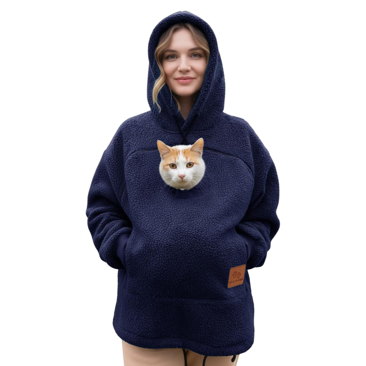 Cat in the pouch of a navy blue Pawdie hoodie