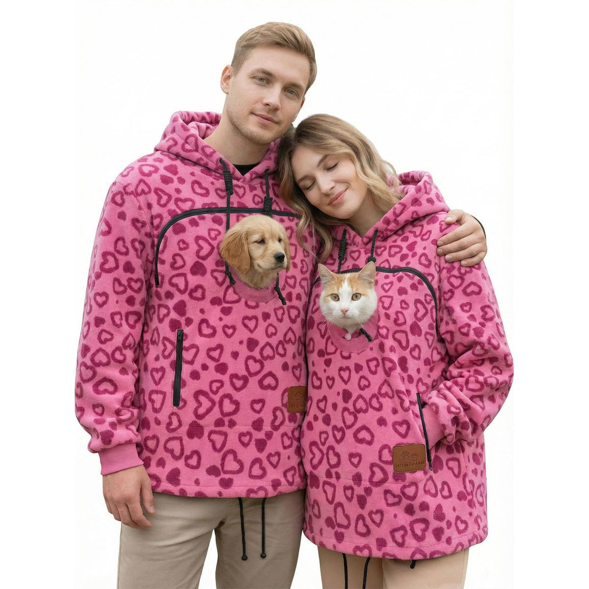 Couple in matching rose red Pawdie hoodies with a dog and a cat